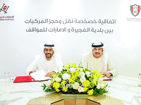(left to right) Abdullah Matar Al Mannai, Chairman and Managing Director of Emirates Parkings, and Mohammad Al Afkham, Director-General of Fujairah Municipality, signing the agreement