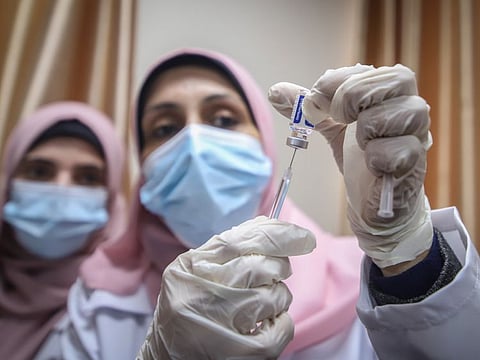 A health worker prepares a dose of the Sputnik V COVID-19 vaccine in a file picture.
