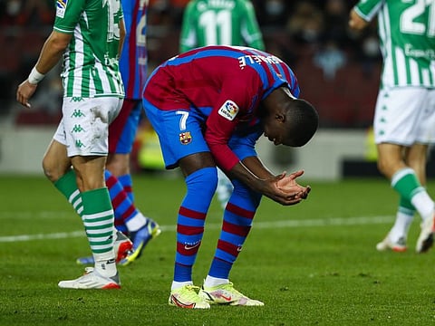 Barcelona's Ousmane Dembele gestures during the Spanish La Liga match against Real Betis at the Camp Nou stadium, in Barcelona, Spain. Barca are in danger of an early exit of this season's Champions League competition.