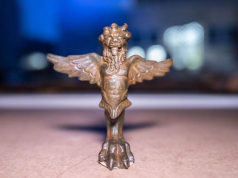 The artifact is a bronze statue of a mythical creature with eagle wings, a lion’s head, and a huge bird’s foot with claws. The statue dates back to the time of the Roman Empire in the first century AD.