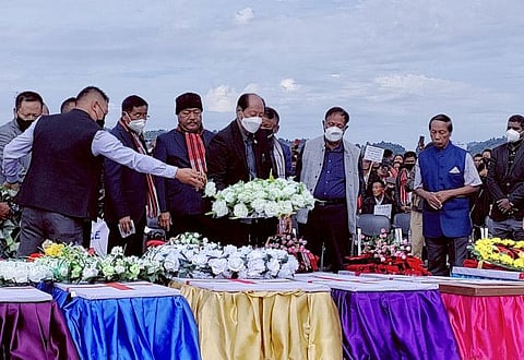 Neiphiu Rio, Chief Minister of the northeastern state of Nagaland, places a wreath on a coffin during a mass funeral of civilians who were mistakenly killed by security forces, in Mon district of Nagaland, India, December 6, 2021.