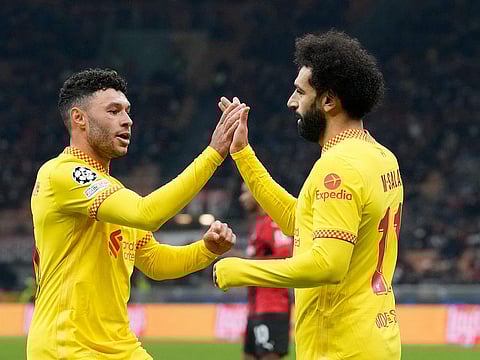 Liverpool's Mohamed Salah, right, celebrates after scoring his side's first goal during the Champions League, Group B soccer match between AC Milan and Liverpool at the San Siro stadium in Milan, Italy, Tuesday, Dec. 7, 2021.