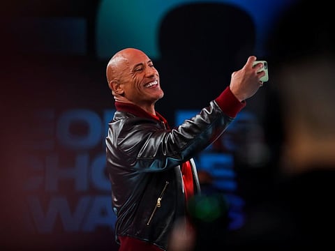 People's Champion Award recipient Dwayne Johnson takes a selfie as he arrives for the 47th ceremony of the People's Choice Awards in Santa Monica, California, U.S., December 7, 2021.