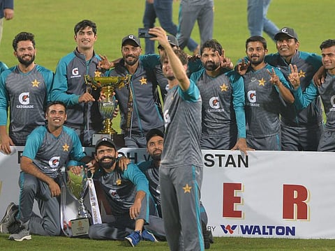 Pakistan's Shaheen Shah Afridi (centre) takes selfies with teammates after wrapping up the second Test match in Dhaka.