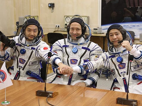 In this photo released by the Roscosmos Space Agency, Roscosmos cosmonaut Alexander Misurkin, center, and spaceflight participants Yusaku Maezawa, right, and Yozo Hirano, left, of Japan, members of the main crew of the new Soyuz mission to the International Space Station (ISS) pose prior to the launch at the Russian leased Baikonur cosmodrome, Kazakhstan, Wednesday.