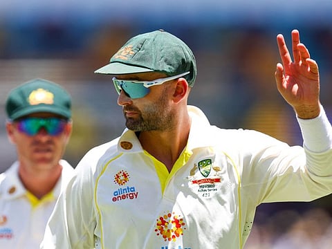 Magic figure: Nathan Lyon acknowledges the crowd after reaching his 400 wickets mark with the wicket of Dawid Malan in Brisbane on Saturday.