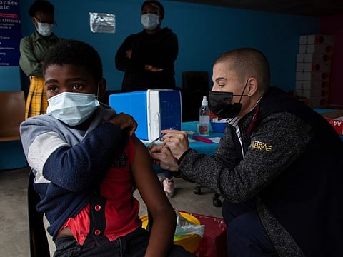 A boy gets vaccinated against COVID-19 at a site near Johannesburg.
