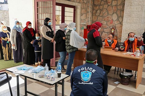 Palestinians at a polling station during municipal elections in the village of Baitain, East of the West Bank city of Ramallah, on December 11, 2021.