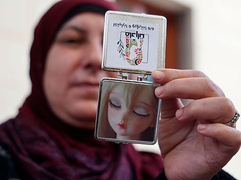 A Palestinian female candidate for local council elections shows a pocket mirror included in campaign merchandise she and others are preparing, in their village of Burqin, west of Jenin in the West Bank.