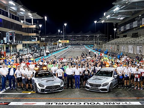 UAE volunteers' team pose at the Yas Marina track in Abu Dhabi.