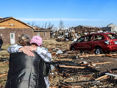Irene Noltner consoles Jody O'Neill outside The Lighthouse, a women and children's shelter that was destroyed by a tornado along with much of the downtown of Mayfield, Kentucky, U.S. December 11, 2021.