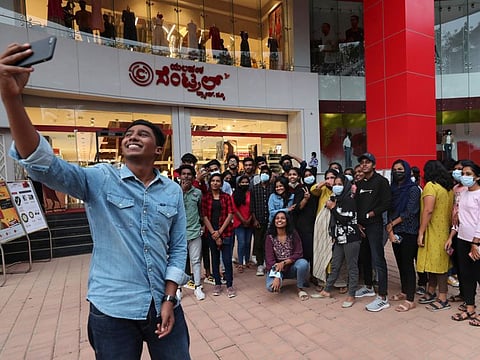 A group of young people outside a shopping mall in Bengaluru, capital of the southern Indian state of Karnataka.
