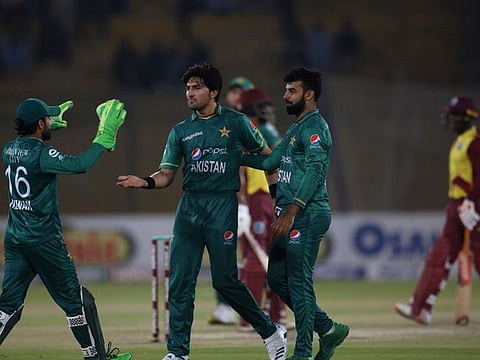 Pakistan's Mohammad Wasim (centre) celebrates with teammates after dismissing West Indies captain Nicholas Pooran during the first Twenty20 match at the National Stadium in Karachi.