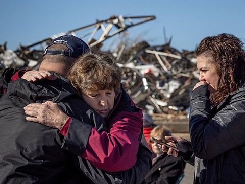 Local residents Darlene Easterwood and Tim Evans embrace after taking part in an outdoor Sunday service with members of First Christian Church and First Presbyterian Church in the aftermath of a tornado in Mayfield, Kentucky.