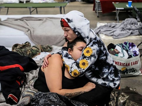 A man comforts his girlfiriend as they stay at the The Way shelter in Wingo, Kentucky.