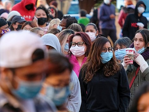Black Friday shoppers wearing face masks wait in line to enter a store at the Citadel Outlets in Commerce, Calif., Friday, Nov. 26, 2021.