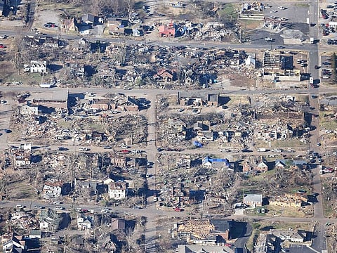 Homes and businesses are badly damaged following a tornado three days prior, on December 13, 2021 in Mayfield, Kentucky.