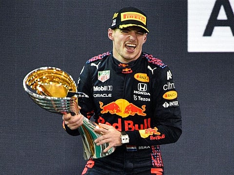 Max Verstappen of Red Bull Racing celebrate after winning the Formula One Etihad Airways Abu Dhabi Grand Prix at the Yas Marina Circuit on December 12, 2021.