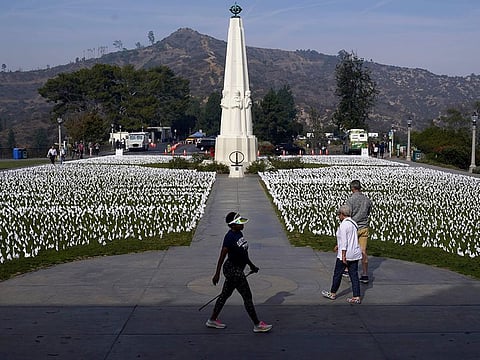 File: Visitors walk around a memorial for victims of COVID-19 at the Griffith Observatory in Los Angeles.