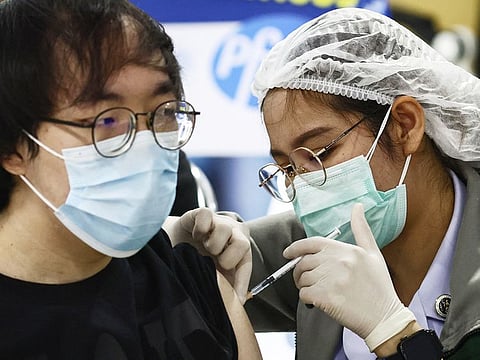 A man receives a COVID-19 vaccine at the Bang Sue Central Vaccination Centre in Bangkok on December 15, 2021.