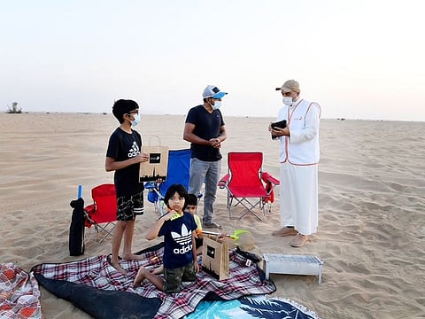 A Dubai Municipality official raising awareness about the 'Our Desert in Beautiful' drive to keep desert areas clean