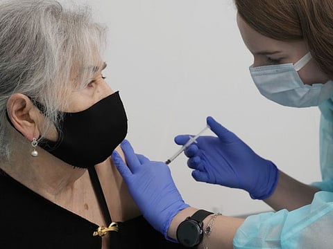 Hanna Zientara, an 83-year-old resident of Warsaw, receives a booster shot against COVID-19.