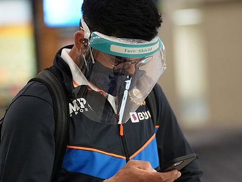 Virat Kohli catches up on his phone on touching down in Johannesburg on Thursday.