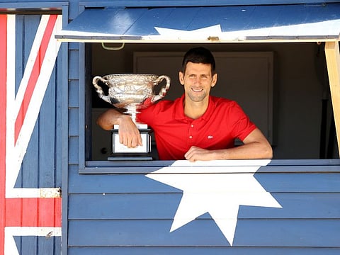 Australian Open champion Novak Djokovic poses with the trophy during a photo shoot at Brighton Beach on February 22 this year.