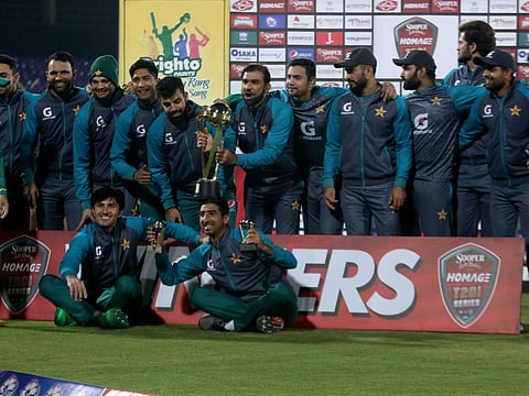 Pakistan players pose with trophy after winning the three-match Twenty20 International series against the West Indies at the National Stadium in Karachi on Thursday.