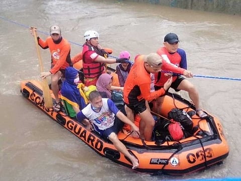 Philippine Coast Guard personnel assist in the evacuation of residents due to flooding caused by Typhoon Rai in Cagayan De Oro City, Philippines, December 16, 2021.