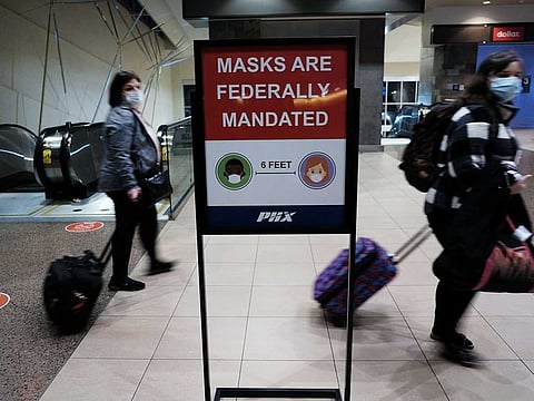 People walk through Sky Harbor International Airport in Phoenix where new COVID-19 cases are down but health experts warn cases may rise with the introduction of the omicron strain on December 18, 2021 in Phoenix, Arizona.