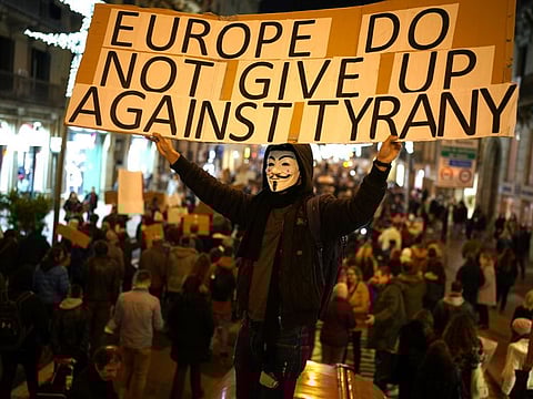 Demonstrators march during a protest to oppose the vaccine pass proposal and ongoing government restrictions in Barcelona, Spain, Saturday, December 18, 2021.