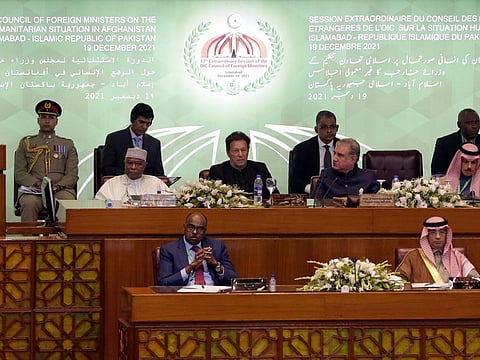 Pakistan Prime Minister Imran Khan, centre, during the 17th extraordinary session of Organisation of Islamic Cooperation (OIC) Council of Foreign Ministers, in Islamabad, Pakistan, Sunday, Dec. 19, 2021. The economic collapse of Afghanistan, already teetering dangerously on the edge, would have a "horrendous" impact on the region and the world, successive speakers warned Sunday at the start of a one-day summit of foreign ministers