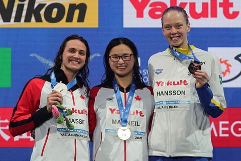 From: Canada's Margaret MacNeil (centre) is flanked by Kylie Masse (left, silver medal) and bronze-medallist Louise Hanson of Sweden at the podium after the 50-metre backstroke final in Abu Dhabi.