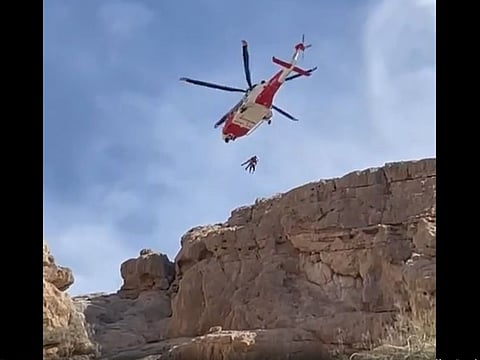 Screengrab of NSRC video of injured mountain climber being airlifted from mountain in Ras Al Khaimah on Tuesday