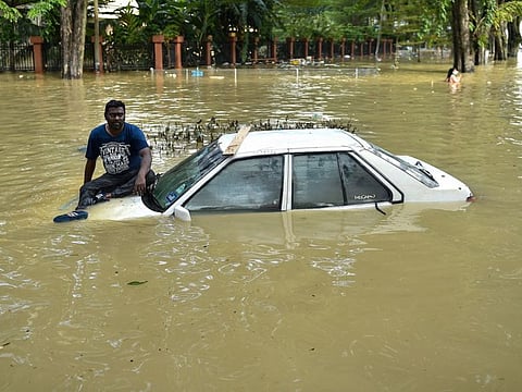 A man waits to be evacuated by a rescue team in Shah Alam, Selangor, in Malaysia.