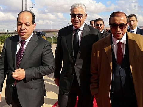 Libya's presidential candidates Ahmed Maiteeq (left) and Fathi Bashagha (centre) arrive for a meeting with Libya's eastern military chief Khalifa Haftar, in the eastern city of Benghazi on December 21, 2021.