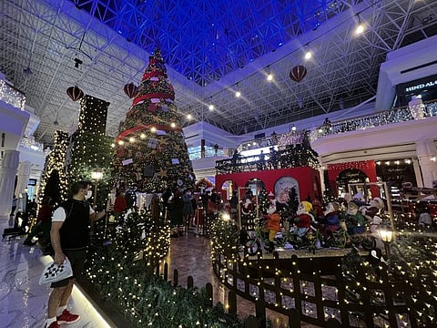 Visitors gather around Christmas decorations at Wafi Mall in Dubai last Tuesday.