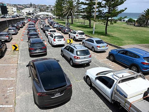 Residents queue up inside their cars for PCR tests at the St Vincent's Bondi Beach COVID-19 drive through testing clinic on December 22, 2021 in Sydney, as the number of COVID-19 cases keeps on the rise across the New South Wales state ahead of the Christmas festivities.