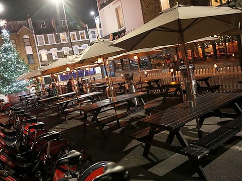 Empty tables at a bar usually crowded with customers in London, amid record-breaking cases in Britain.
