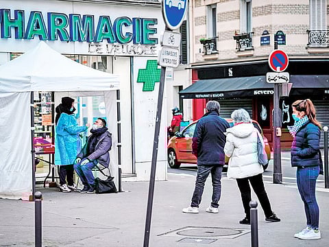 Patients waiting to be tested for COVID-19 in Paris on Thursday.