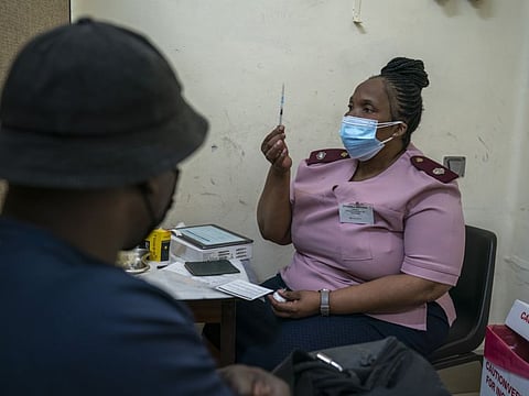 A nurse explains the vaccination procedure before administering a dose of the Pfizer COVID-19 vaccine at a clinic in Johannesburg.