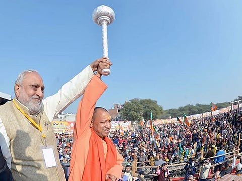 Uttar Pradesh Chief Minister Adityanath holds a mace at a rally ahead of Uttar Pradesh Legislative Assembly election 2022, in Mathura on Sunday.