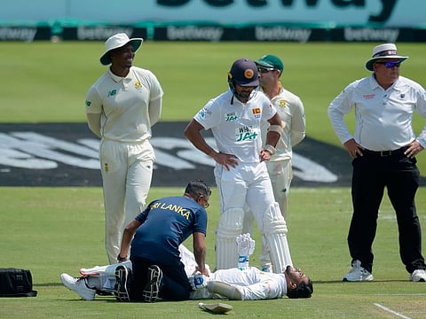 Sri Lanka's Dhananjaya de Silva receives medical attention during the first day of the first Test cricket match between South Africa and Sri Lanka at SuperSport Park in Centurion