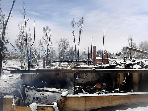 Steam rises from the snow-covered remains of homes destroyed by the Marshall Fire in the Rock Creek neighborhood of the town of Superior in Boulder County, Colorado on January 1, 2022.