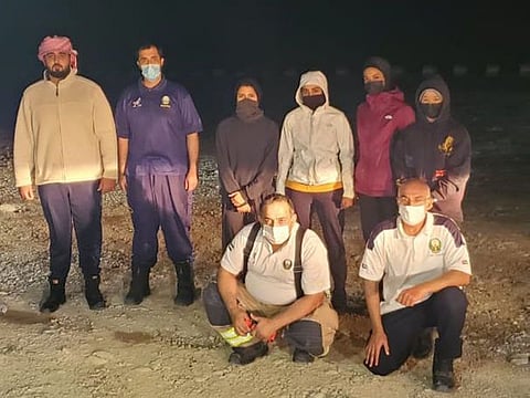 The four women with their rescuers.