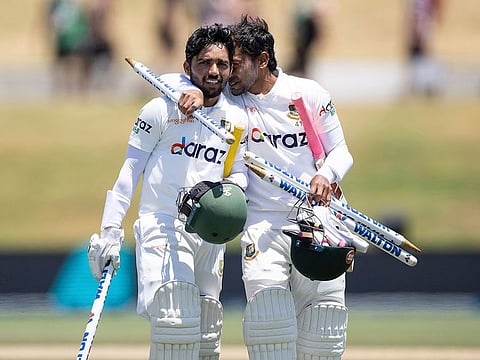 Captain Mominul Haque, left, and team mate Mushfiqur Rahim walk from the field after their win during play on day five of the first cricket test between Bangladesh and New Zealand at Bay Oval in Mount Maunganui, New Zealand, Wednesday, Jan. 5, 2022.