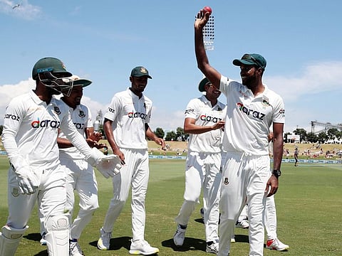 Ebadot Hossain (right) of Bangladesh celebrates his six-wicket haul on the fifth day of the first cricket Test against New Zealand at the Bay Oval in Mount Maunganui on January 5, 2022.