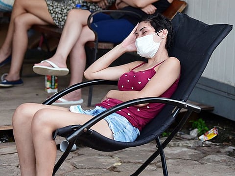 A woman waits to be tested for the COVID-19 at a public hospital in Asuncion on January 4, 2022 as health centres are starting to collapse due to an increase in COVID-19 cases brought on by the rapidly spreading Omicron variant.