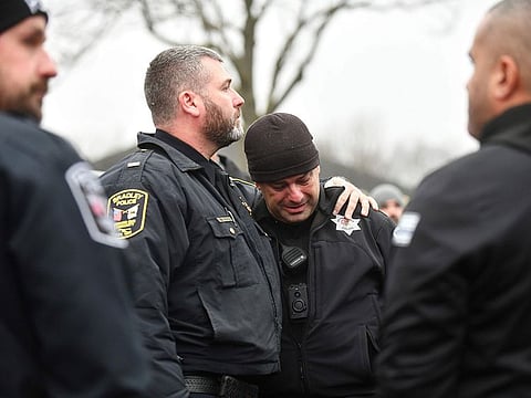 Bradey Police Lt. Philip Trudeau, left, comforts Bourbonnais Police officer Andy Cox following a ceremonial procession for fallen Bradley Police Sgt. Marlene Rittmanic.